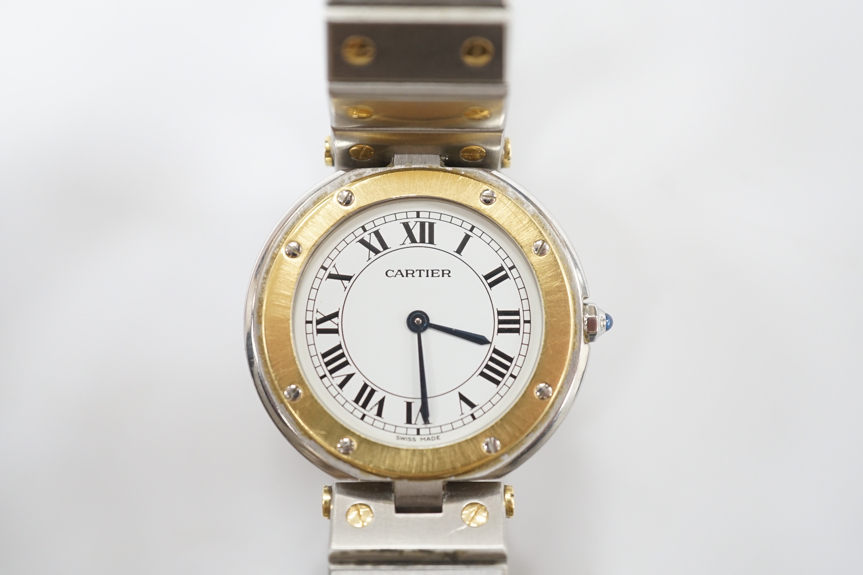 A steel and gold Cartier Ronde Vendom quartz wrist watch, with Roman dial, on a Cartier steel and gold bracelet, with Cartier pouch, no box or papers, case diameter 32mm.